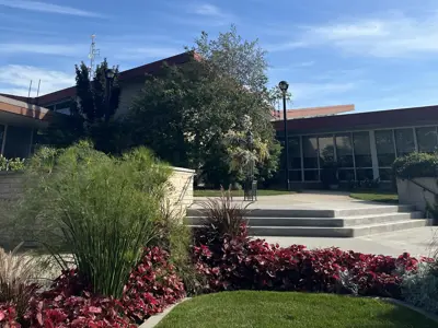 A photo of the walking path and gardens leading up to Steinbach City Hall